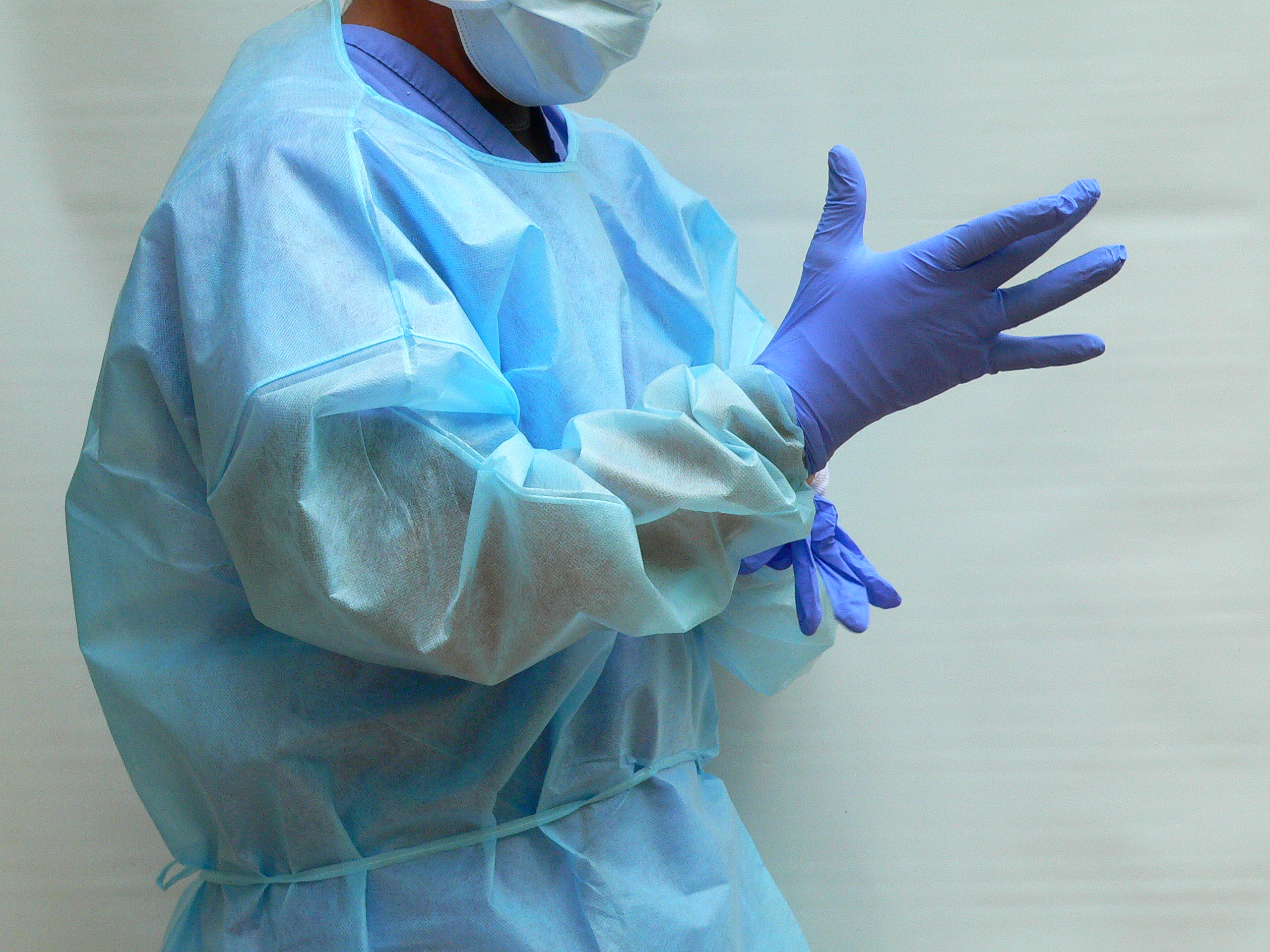 Disposable PE coated level 2 isolation gowns with knit cuffs. Blue color.